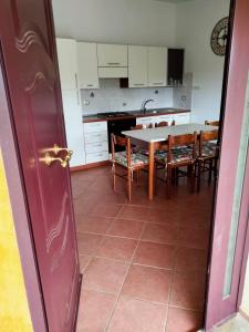 a kitchen and dining room with a table and chairs at Casa Antonietta in Santa Lucia