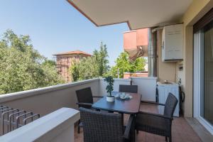 a patio with a table and chairs on a balcony at Hotel Consul - Family Hotel in Riccione