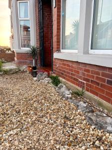 a house with a pile of rocks in front of a house at Blackpool Rocks Pleasure Beach in Blackpool