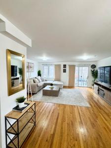 a living room with a couch and a table at Stylish Evergreen Apartment By Newark Airport in Newark