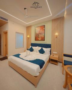 a bedroom with a large bed with a blue headboard at The Grand Maan Palace and Resort- Near Vaishali Nagar I New Building in Jaipur +35 photos