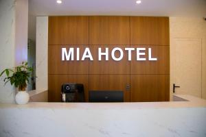 a mica hotel sign on a wooden wall at Mia Hotel Cửa Lò in Vinh