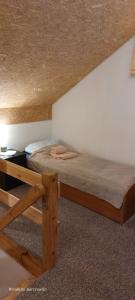 a bedroom with a wooden bed and a desk at Chata pod kogutem in Barczewko