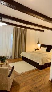 a bedroom with a bed and a couch and a chair at Festung 57 in Bran +48 photos