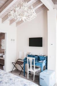 a bedroom with a blue desk and a chandelier at B&B La Fiaba in Sirmione