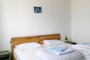 two beds in a room with towels on them at MIA Apartment in Yambol