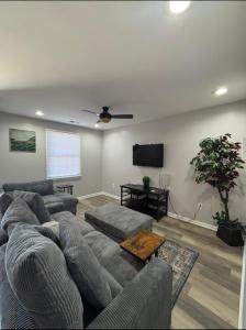 a living room with a couch and a flat screen tv at Riverside Retreat in Camden