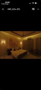 a bedroom with a large bed and a room with at Tiffany by SS castles in Sohāna