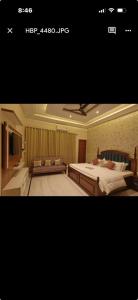 a bedroom with a large bed and a couch at Tiffany by SS castles in Sohāna