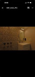 a bathroom with a sink and a mirror and a toilet at Tiffany by SS castles in Sohāna