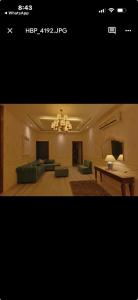 a living room with a couch and a chandelier at Tiffany by SS castles in Sohāna