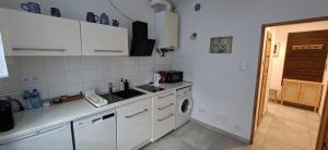 a kitchen with a sink and a washing machine at 91 kroków - 91 steps free parking in Bolesławiec
