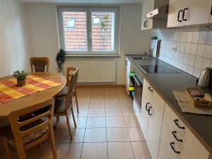 a kitchen with a table and a table and chairs at Steinlachquartier in Dußlingen