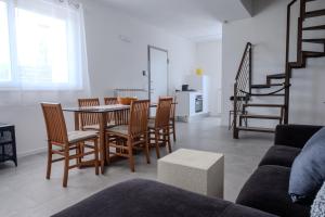 a living room with a dining room table and chairs at Villa Molin Bianco in Arezzo
