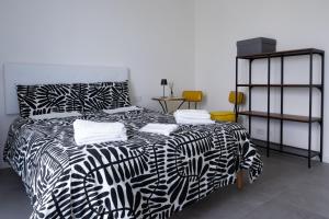 a bedroom with a black and white bed and a table at Villa Molin Bianco in Arezzo