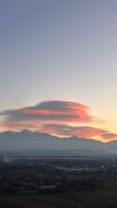 a view of a sunset with mountains in the background at Hostel Cora in Haţeg