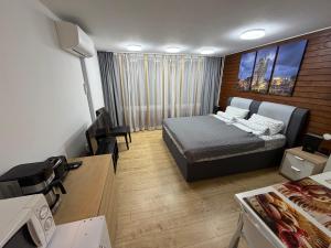 a bedroom with a bed and a desk with a tv at WiLDBADFERiEN DE in Bad Wildbad
