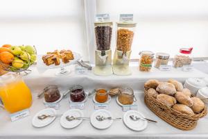 a refrigerator filled with breakfast foods and orange juice at HI Castelo Branco - Pousada de Juventude in Castelo Branco