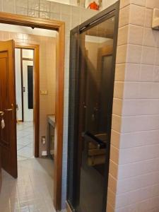 a bathroom with a glass door and a tile wall at A CASA DI GEMMA in Bologna +53 photos