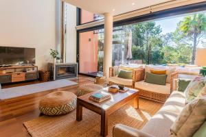 a living room filled with furniture and a large window at Troia Ocean Breeze Villa in Troia