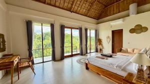 a bedroom with a bed in a room with windows at Jungle Valley Villas in Susut +36 photos