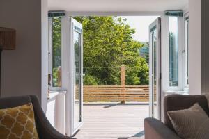 an open door leading to a porch with a deck at Beachcomber in Croyde