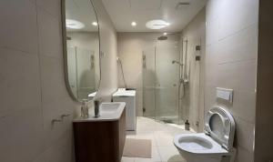 a bathroom with a toilet and a sink and a shower at Prime Central Oslo - Frogner, All-Inclusive Apartment in Oslo +12 photos