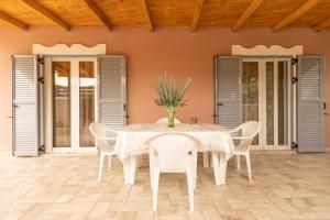 a white table and chairs on a patio at Nikorina apts in Lefkada