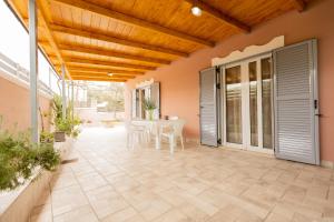 a patio with a table and chairs on it at Nikorina apts in Lefkada