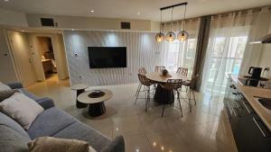 a living room with a couch and a table at Orins place eilat in Eilat