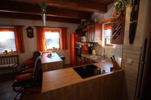 a kitchen with red cabinets and a counter top at Orange House in Kladenské Rovné