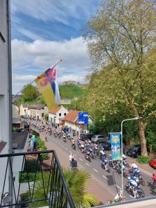 a group of motorcyclists are riding down a street at Logement viphouse Valkenburg in Valkenburg