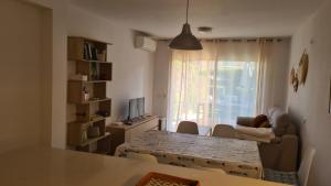 a living room with a table and a couch and a window at Casa Mistral in Palamós