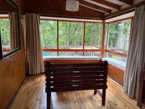 a room with a bench in front of a window at Cabañas y Domos Calafquen in Coñaripe