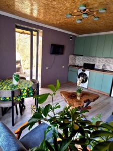 a living room with a table and a stove at Guest House Aspindza in Aspindza +29 photos