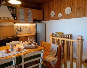 a kitchen with a wooden table and a refrigerator at La Chiave del Gufo - Bojano in Boiano