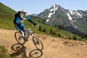 a person riding a bike on a dirt road at Croix Apartment - Snow and Trek - Morzine in Morzine