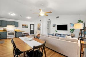 a living room with a couch and a table at Sea Swept Cottage OBX in Kill Devil Hills