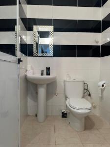 a bathroom with a toilet and a sink at appartement confortable in Berkane +28 photos
