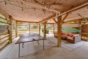 a ping pong table in the middle of a room at Sea Swept Cottage OBX in Kill Devil Hills