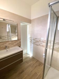 a bathroom with a tub and a sink and a shower at Cygnus Bed & Breakfast in Lido di Jesolo