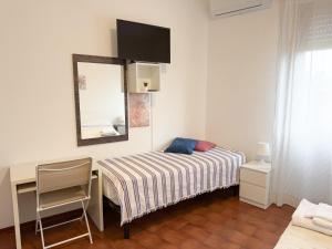 a bedroom with a bed and a desk and a mirror at Da Vinci Rooms in Vinci