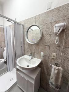 a bathroom with a sink and a mirror at Da Vinci Rooms in Vinci
