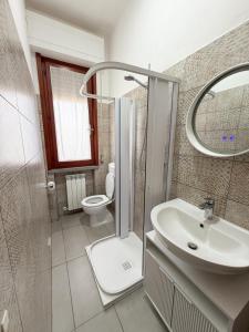 a bathroom with a shower and a sink and a toilet at Da Vinci Rooms in Vinci