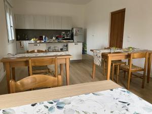 a kitchen with a table and chairs and a kitchen with a counter at Cygnus Bed & Breakfast in Lido di Jesolo