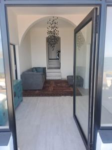 a mirror in a living room with a couch at 210 on Main in Kalk Bay +1 photo