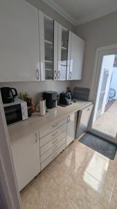 a kitchen with white cabinets and a counter top at Casa Ursula in Los Alcázares