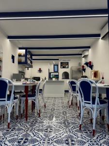 a dining room with tables and chairs on a patterned floor at Al Campanile Suites in Sant'Agnello