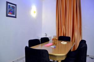 a conference room with a wooden table and chairs at New Benin Home in Benin City