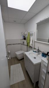 a bathroom with a sink and a toilet and a mirror at Casa Ursula in Los Alcázares +17 photos